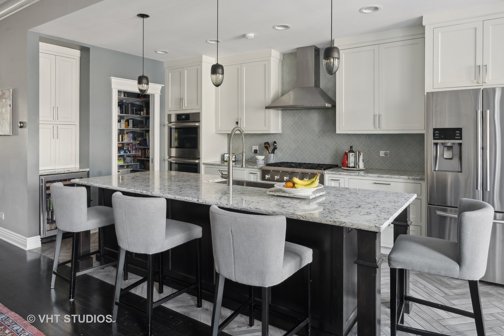 1750 West School Street Chicago, IL 60657 - Photo 5 of 37 a kitchen with stainless steel appliances granite countertop a stove a refrigerator a kitchen island a dining table and chairs