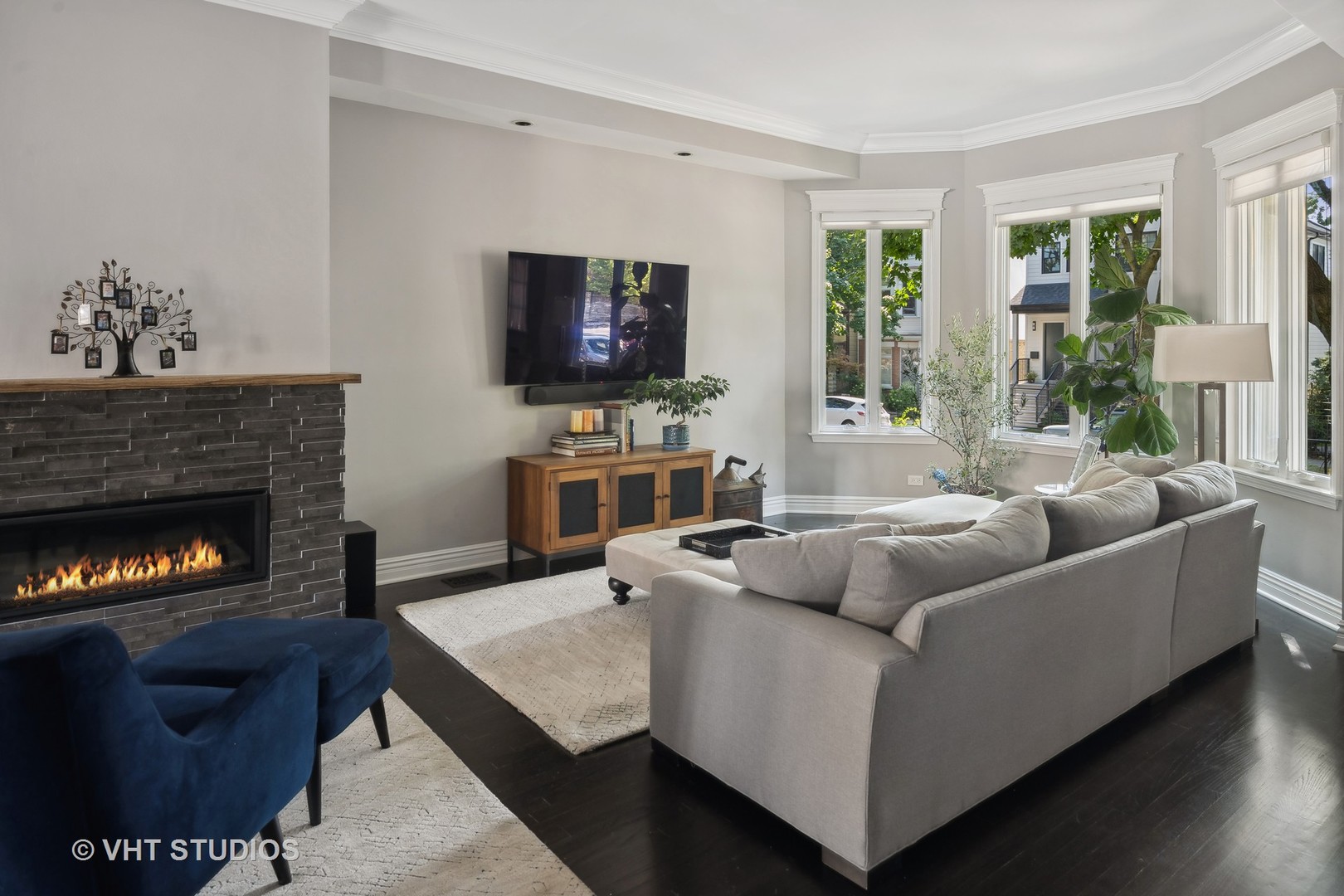 1750 West School Street Chicago, IL 60657 - Photo 10 of 37 a living room with furniture a flat screen tv and a fireplace