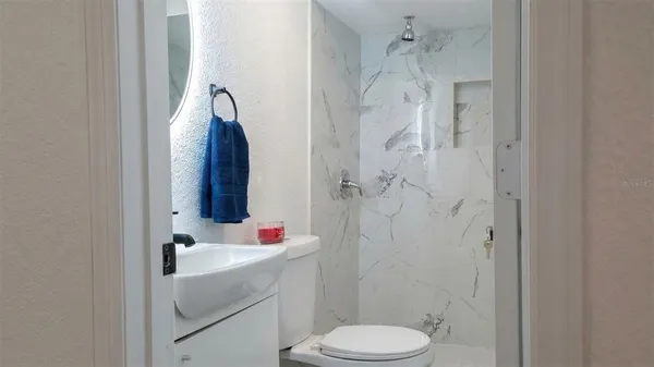 a bathroom with a sink toilet and shower