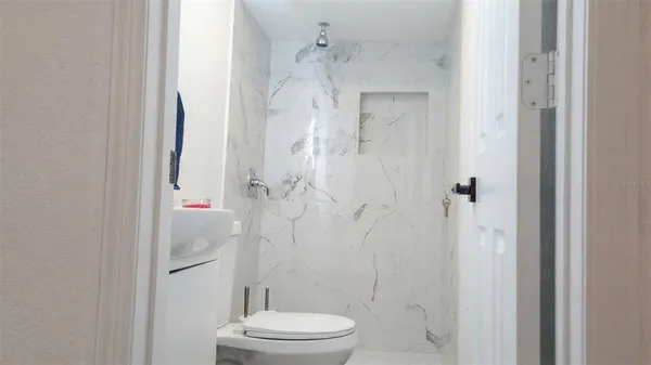 a bathroom with a toilet and shower