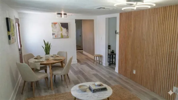 a view of a dining room with furniture and wooden floor