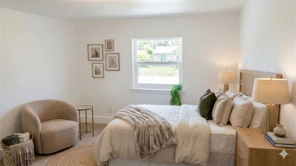 a bedroom with a bed a couch and a window