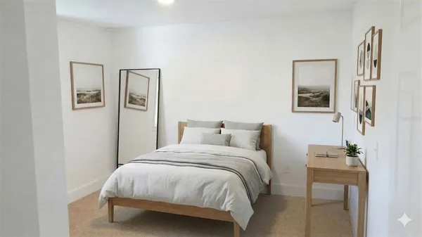 a bedroom with a bed and a painting on the wall