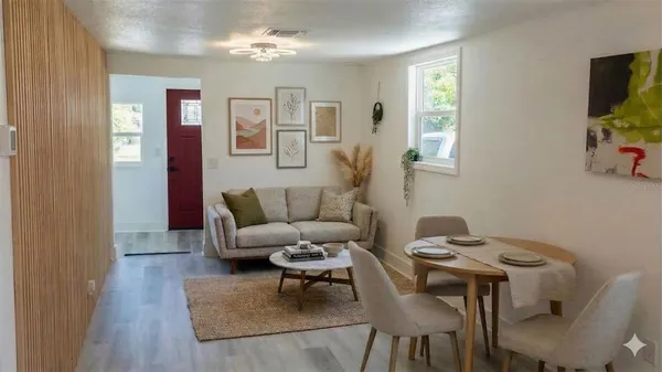 a living room with furniture and a wooden floor