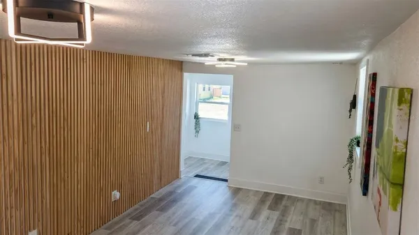 wooden floor in an empty room with a mirror