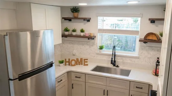 a kitchen with stainless steel appliances a refrigerator and a sink