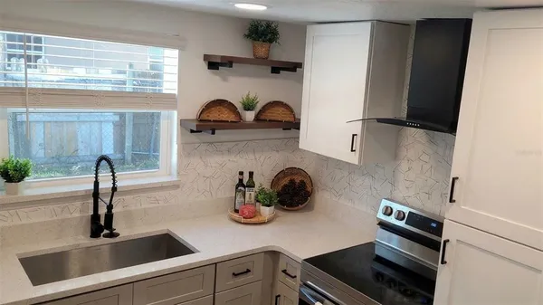 a kitchen with a sink and refrigerator