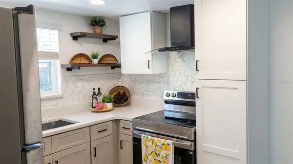 a kitchen with stainless steel appliances a sink and cabinets