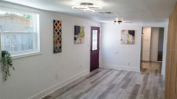 wooden floor in an empty room with a window