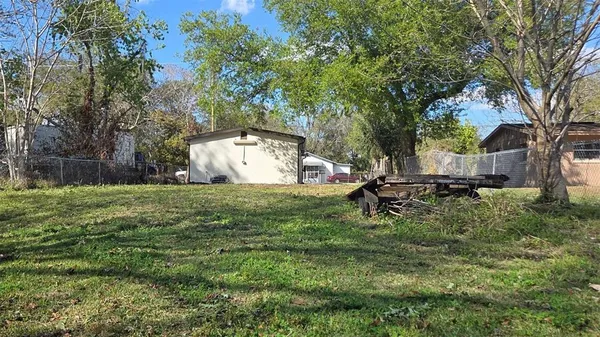 a backyard of a house with table and chairs