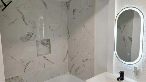 a bathroom with a sink a toilet and a mirror