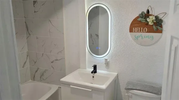 a bathroom with a sink a mirror and a shower