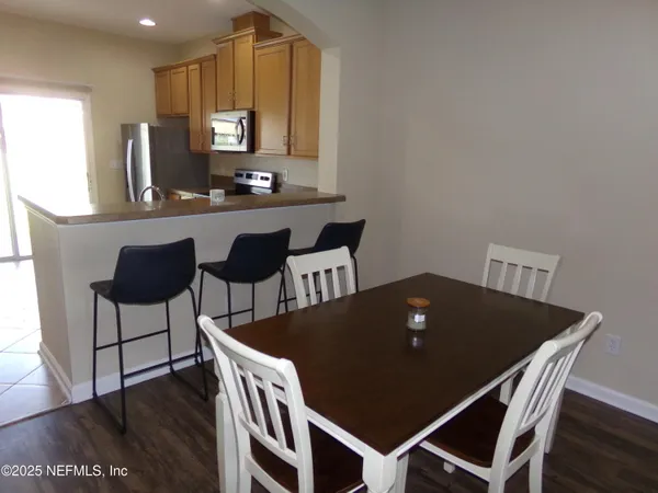 a living room with furniture a dining table and a piano