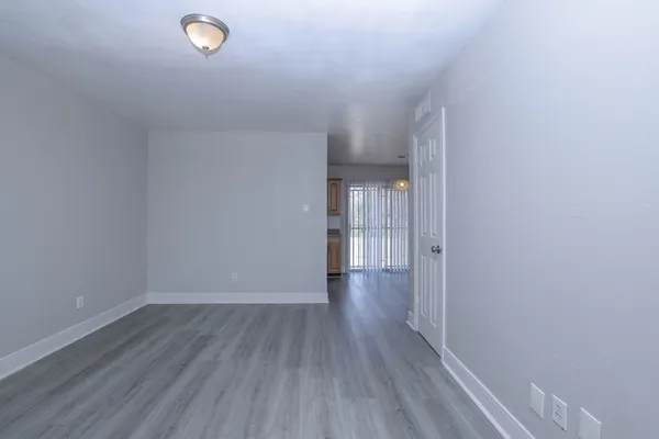 a view of a room with wooden floor