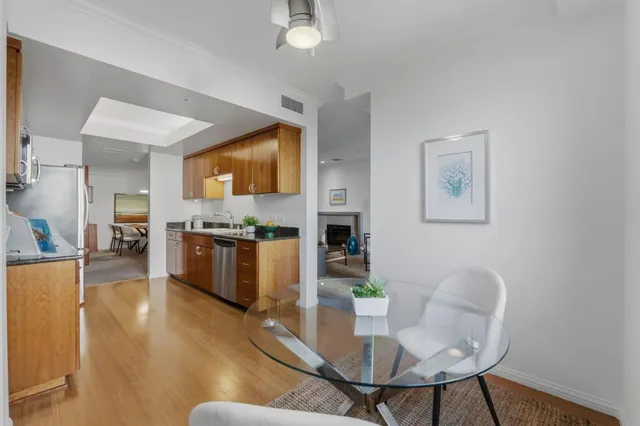 a living room with furniture kitchen view and a flat screen tv