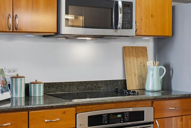 a kitchen with granite countertop a sink and cabinets