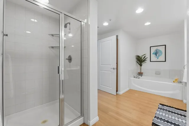 a bathroom with a bathtub and a shower
