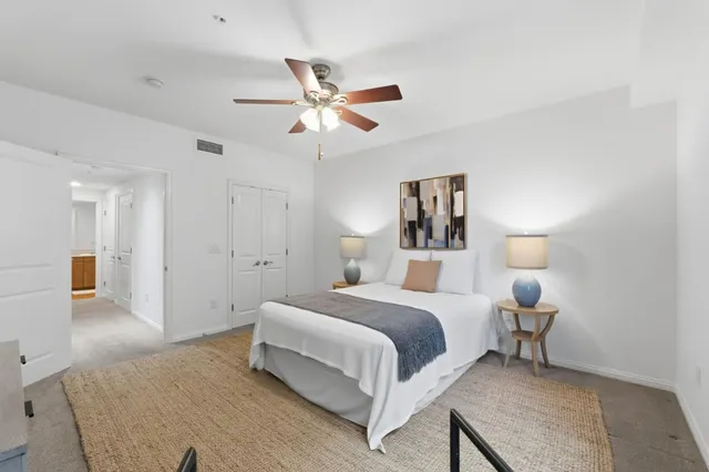 a bedroom with a bed and a chandelier