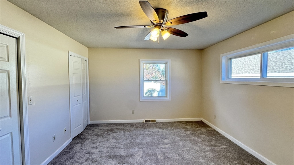 16 Collins Street, Unit 16 Chicopee, MA 01022 - Photo 14 of 31 a view of a big room with a chandelier fan and windows