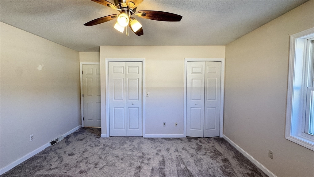 16 Collins Street, Unit 16 Chicopee, MA 01022 - Photo 15 of 31 a view of an empty room and window with a chandelier fan
