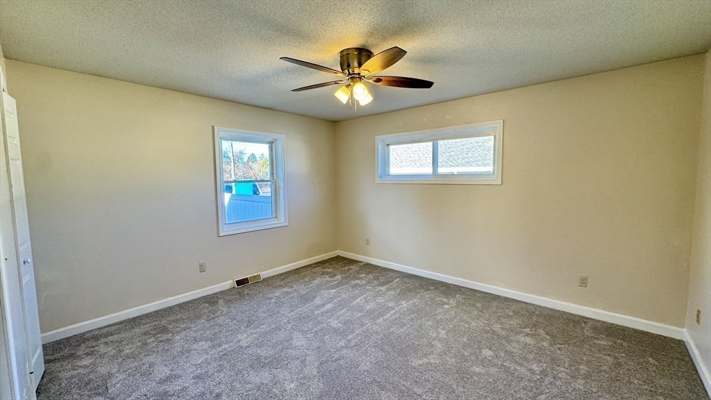 16 Collins Street, Unit 16 Chicopee, MA 01022 - Photo 17 of 31 an empty room with window and ceiling fan