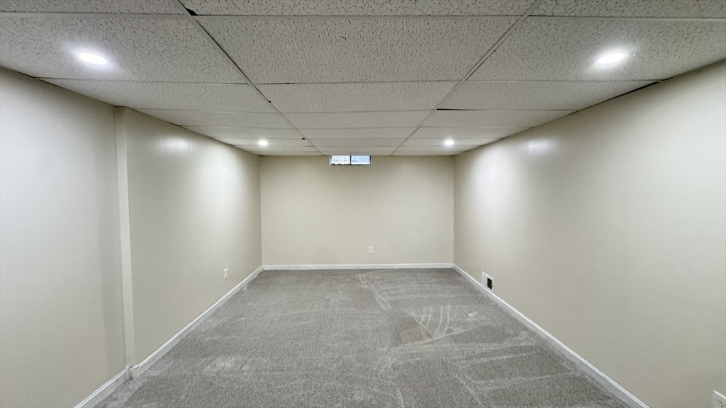 16 Collins Street, Unit 16 Chicopee, MA 01022 - Photo 26 of 31 an empty room with a space and windows