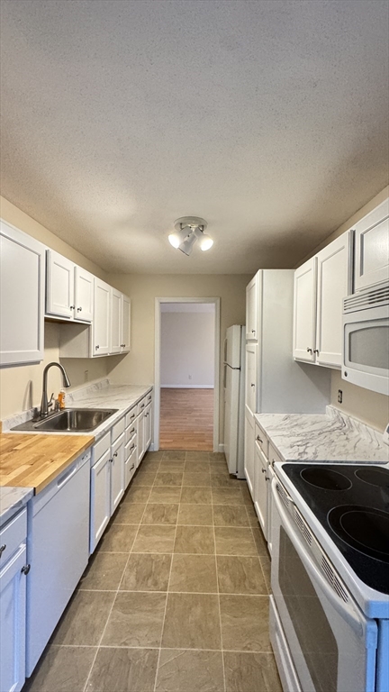 16 Collins Street, Unit 16 Chicopee, MA 01022 - Photo 6 of 31 a large kitchen with stainless steel appliances granite countertop a sink and cabinets