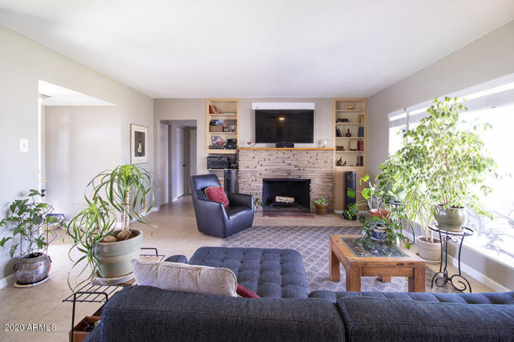 1414 East Coronado Road Phoenix, AZ 85006 - Photo 5 of 13 a living room with furniture a flat screen tv and a fireplace
