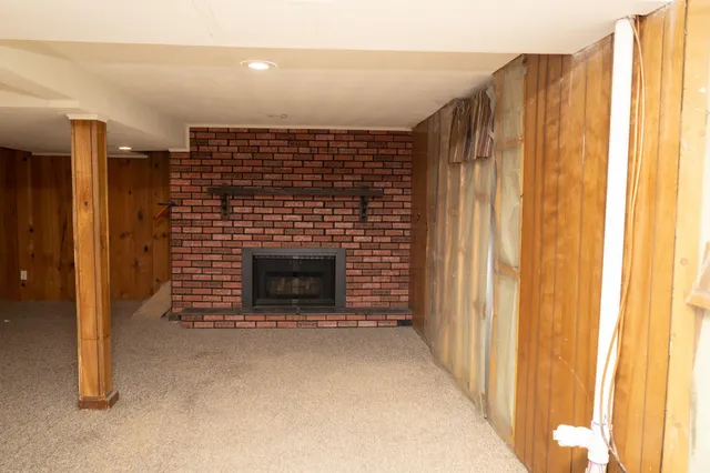 a view of an empty room with a fireplace