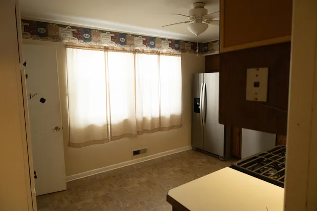 a bathroom with a glass shower door and a window