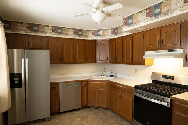 a kitchen with a sink stove and refrigerator