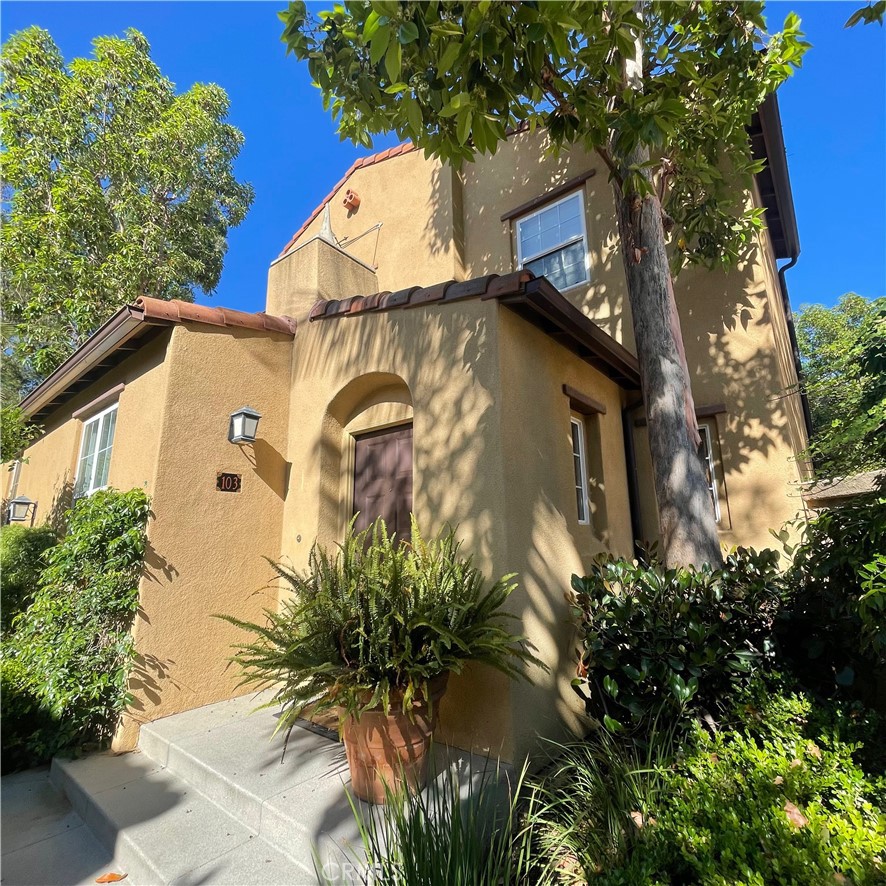 a view of a house with a tree