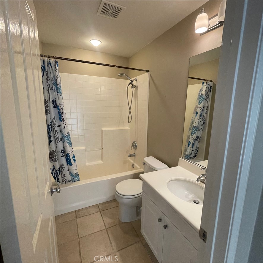 103 Windchime Irvine, CA 92603 - Photo 12 of 16 a bathroom with a granite countertop sink a toilet and shower