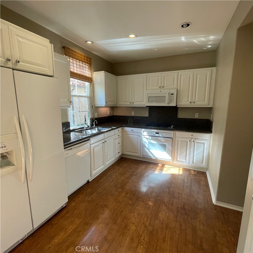 103 Windchime Irvine, CA 92603 - Photo 3 of 16 a kitchen with granite countertop a stove a sink and a refrigerator