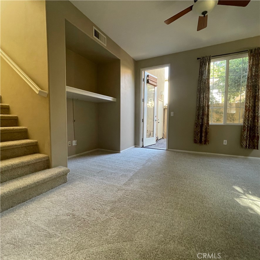 103 Windchime Irvine, CA 92603 - Photo 5 of 16 a view of an empty room with stairs and a window