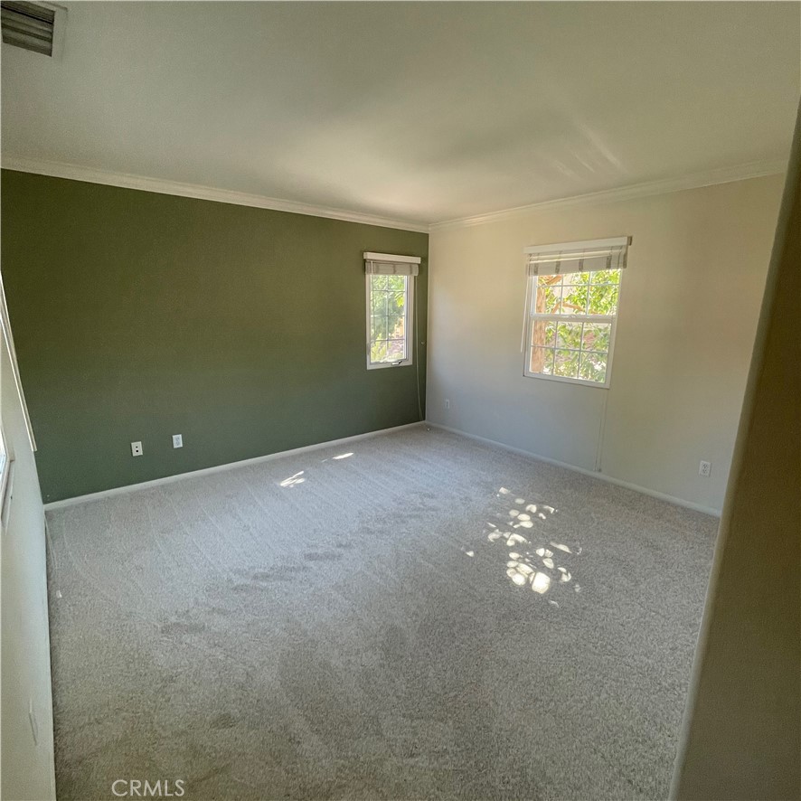 103 Windchime Irvine, CA 92603 - Photo 7 of 16 an empty room with windows and chandelier fan