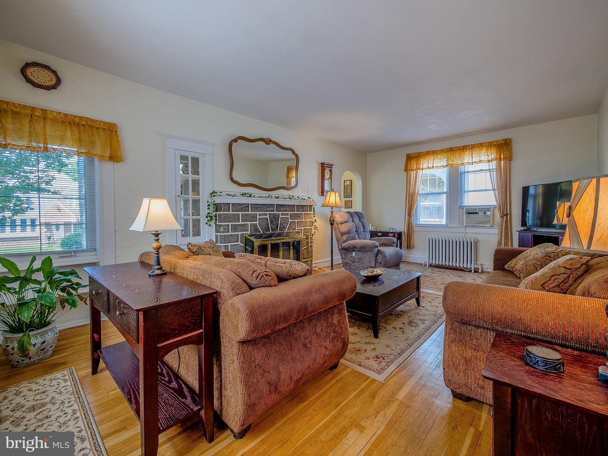 7205 Wayne Avenue Upper Darby, PA 19082 - Photo 27 of 84 a living room with furniture fireplace and a large window