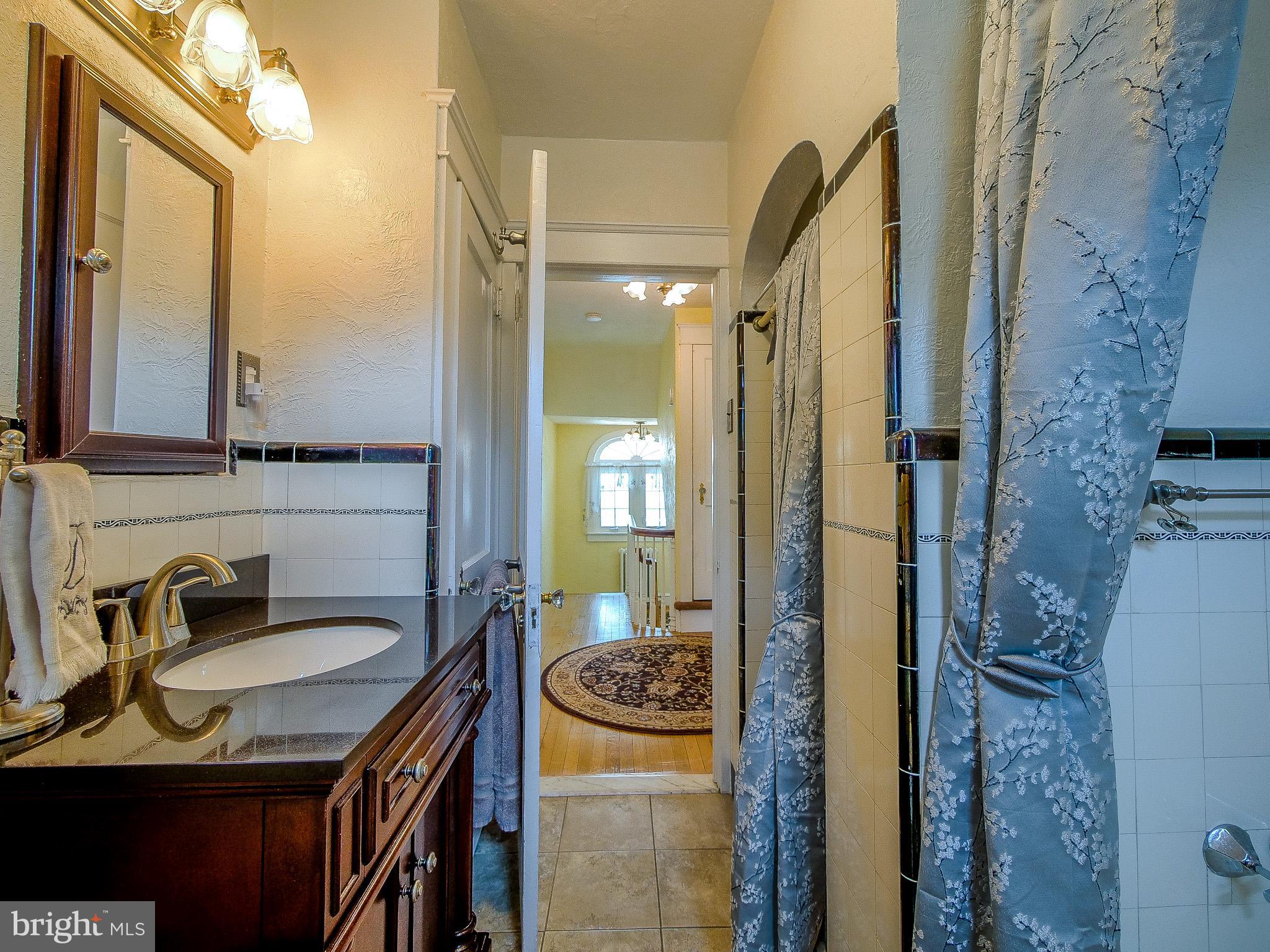 7205 Wayne Avenue Upper Darby, PA 19082 - Photo 59 of 84 a en suite bathroom with a sink and a mirror