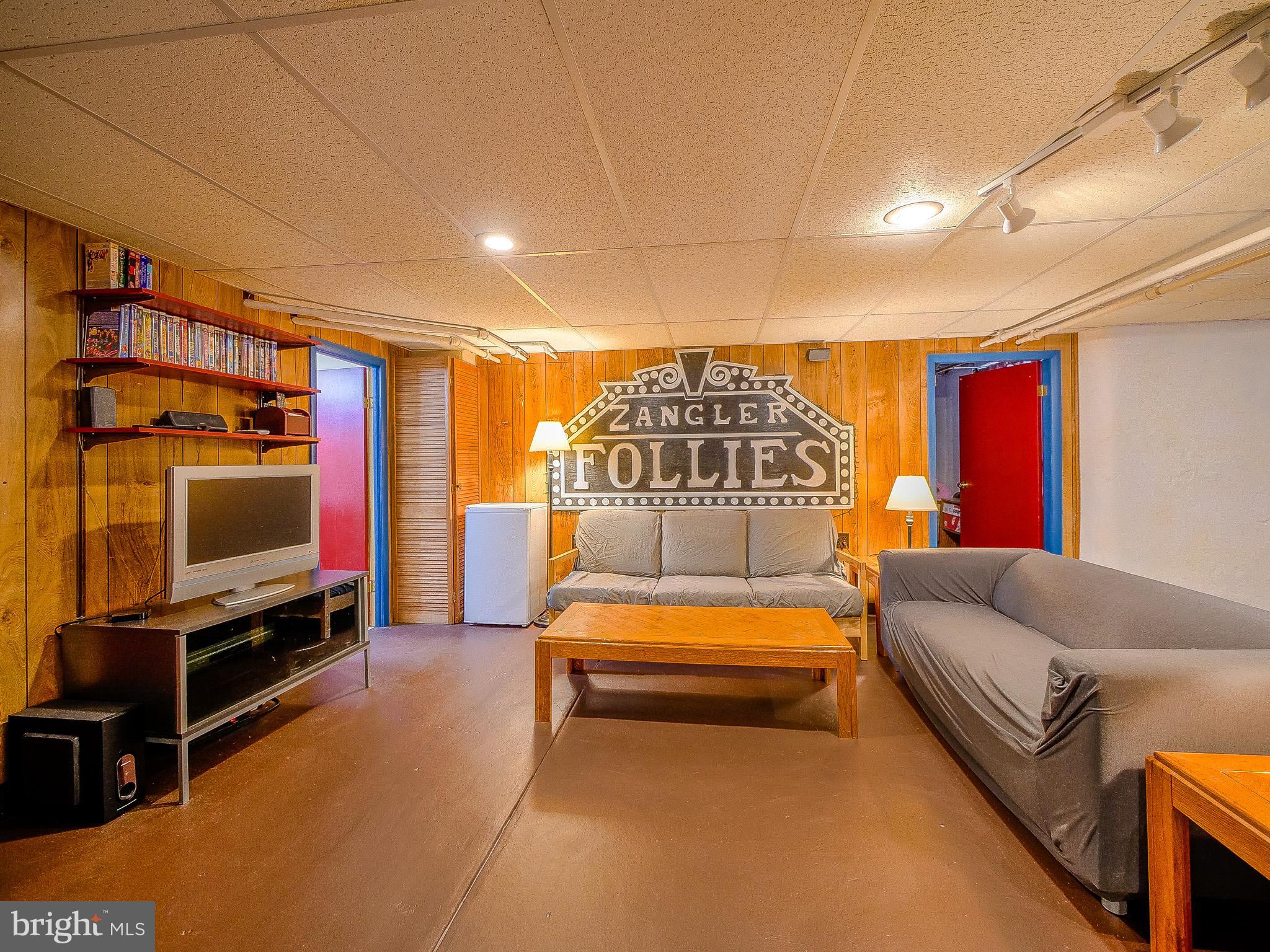 7205 Wayne Avenue Upper Darby, PA 19082 - Photo 76 of 84 a living room with furniture a flat screen tv and gym equipment