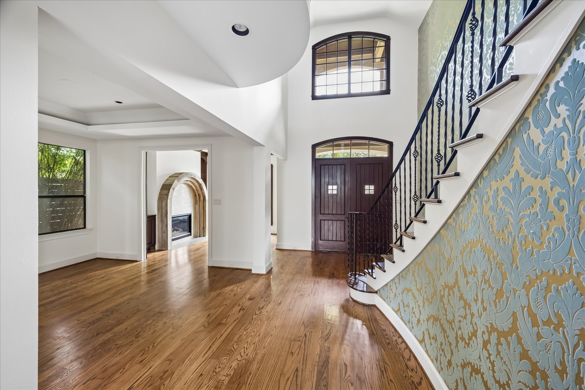 2246 Branard Street Houston, TX 77098 - Photo 3 of 40 Dramatic foyer featuring soaring ceilings, wrought iron staircase, and warm wood floors throughout.