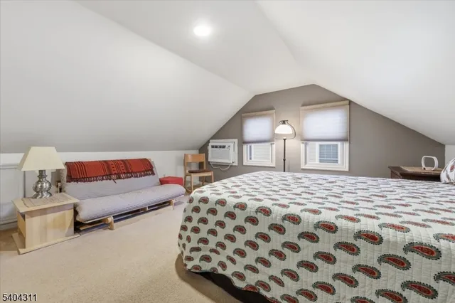 a bedroom with a bed and a lamp