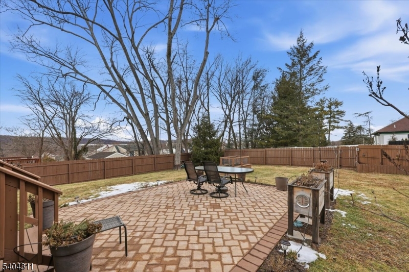 24 Ozone Avenue Cedar Grove, NJ 07009 - Photo 31 of 36 a view of a patio with dining table and chairs with wooden fence