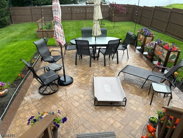 a view of outdoor dining space with furniture and garden
