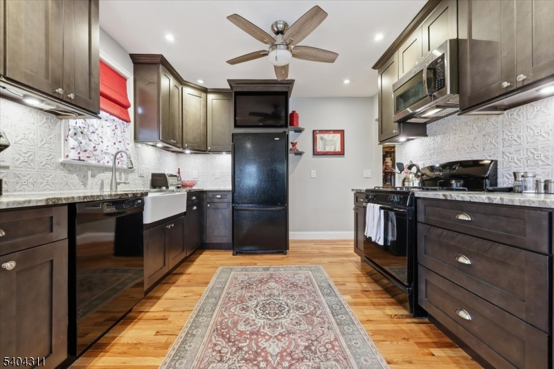 24 Ozone Avenue Cedar Grove, NJ 07009 - Photo 8 of 36 a kitchen with stainless steel appliances granite countertop a refrigerator a stove and a sink