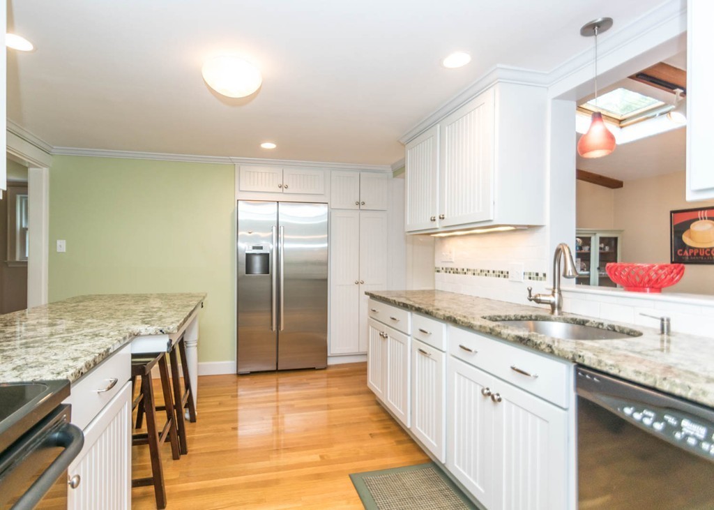 8 Nobscot Road Wellesley, MA 02482 - Photo 6 of 28 a kitchen with stainless steel appliances granite countertop a sink stove and refrigerator