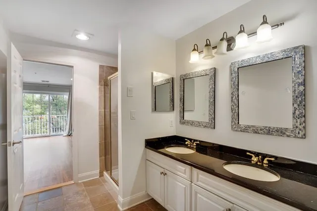 a bathroom with a double vanity sink and a mirror
