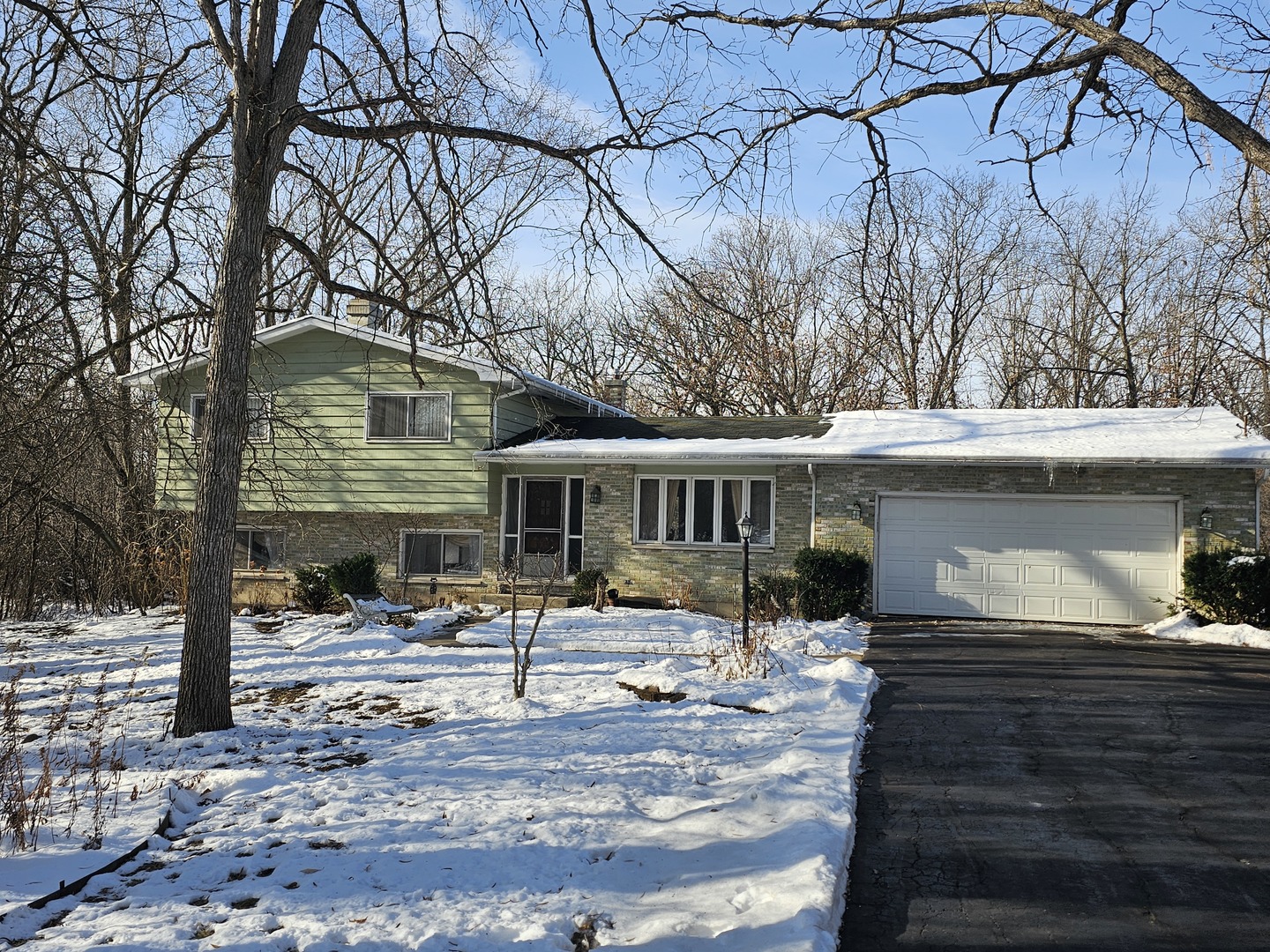 26890 North Longwood Road Lake Forest, IL 60045 - Photo 2 of 15 a front view of a house with trees and covered with snow