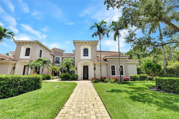 a front view of a house with a garden and plants
