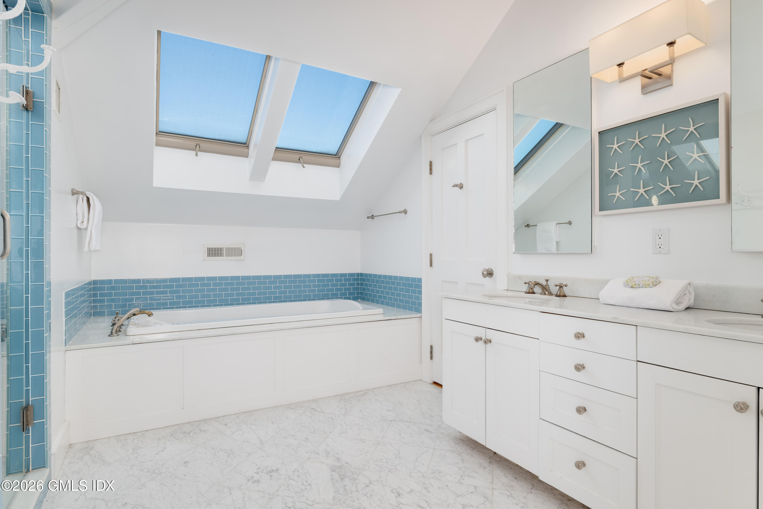 189 Shore Road Old Greenwich, CT 06870 - Photo 23 of 38 a bathroom with a tub a sink and mirror