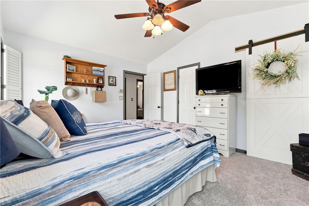 1009 Willow Run Anderson, SC 29621 - Photo 17 of 46 Vaulted ceilings and plush carpeting enhance this serene bedroom space with a barn door feature.